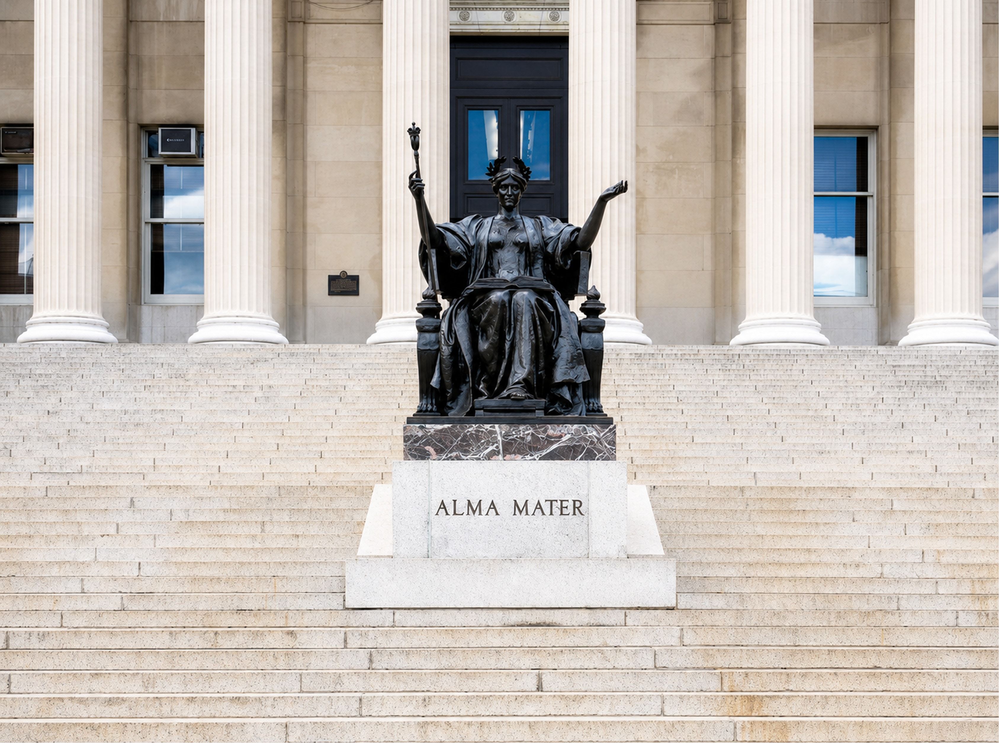 The Alma Mater statue seated before a colonnade